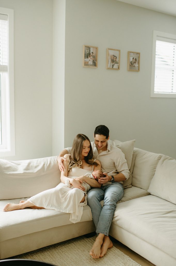 couple on couch with newborn