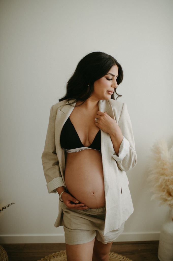 pregnant woman in suit in studio