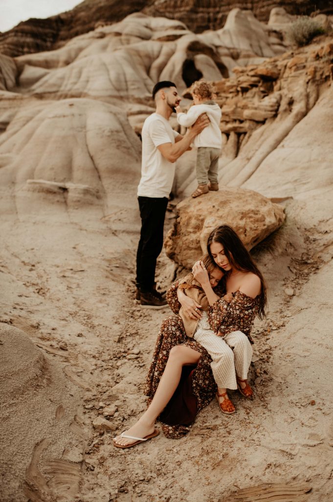 Family snuggling in desert
