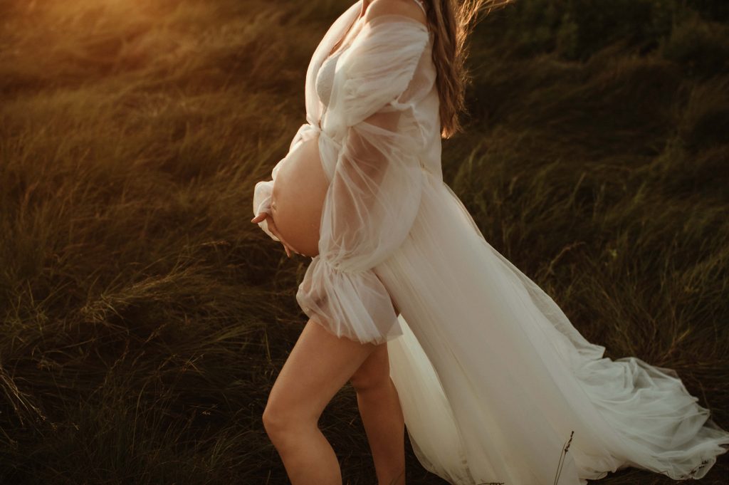 maternity photography on beach at sunset