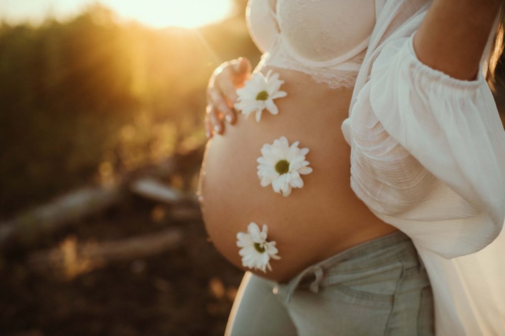 pregnant woman with flowers on belly