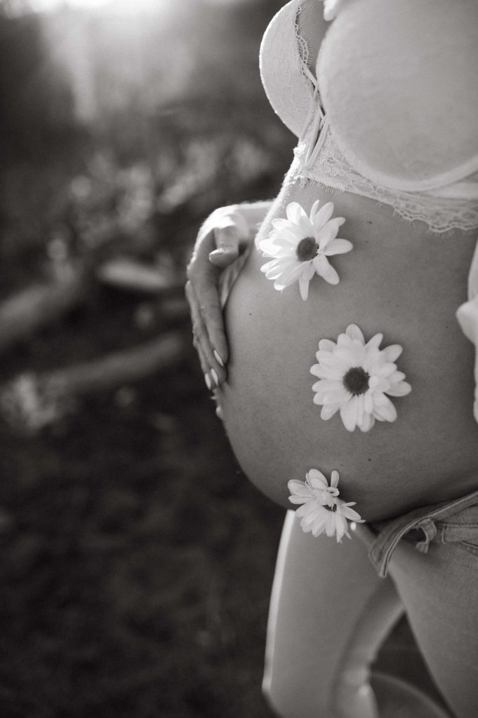 pregnant womant with flowers on belly black and white