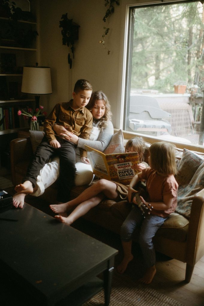 family sitting on couch reading family photography session