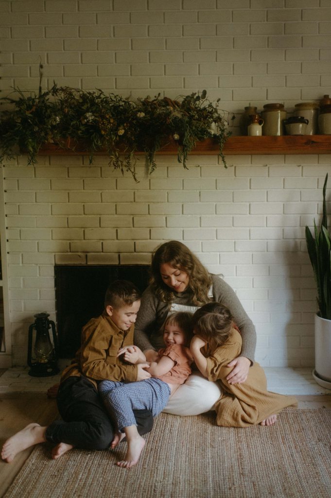 family sitting in front of fireplace family photography session
