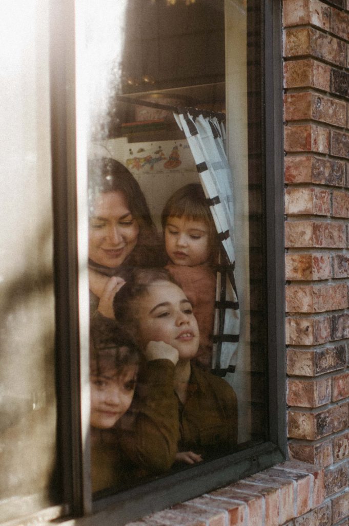 family looking out kitchen window family photography session