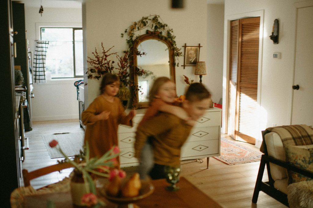 kids running around in house in-home family session