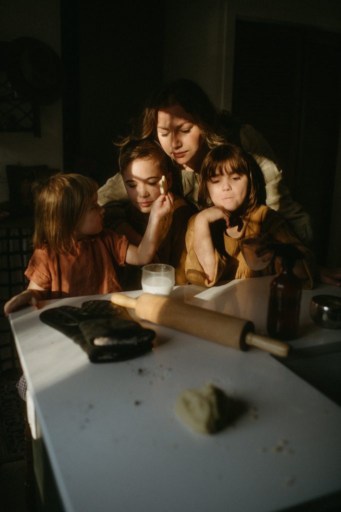 family eating cookies with golden light in-home family photography session