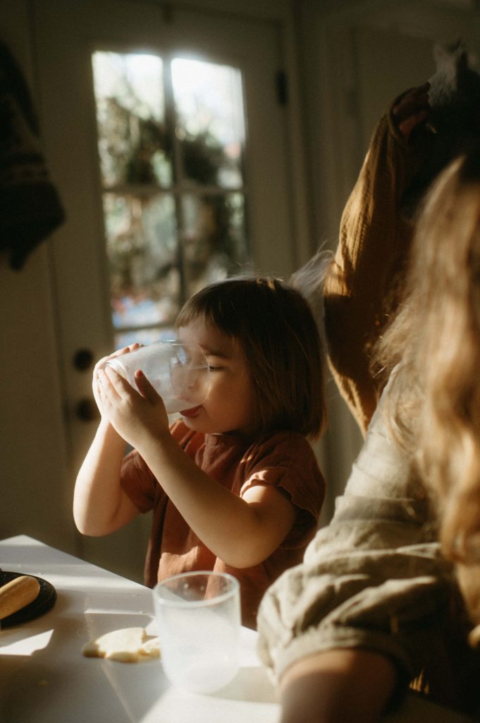 little girl drinking milk in-home session