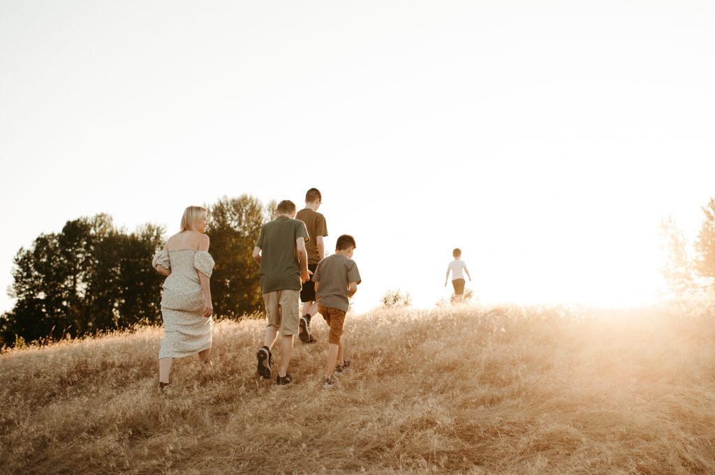 family walking up hill with golden light lower mainland bc, best locations